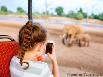 Will I Be Able to Use My Smartphone on Safari? Child on phone on game drive.